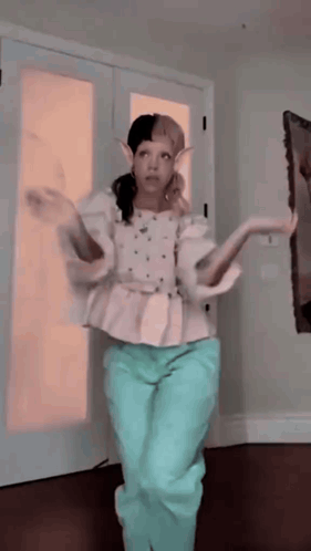 Woman in White Top and Blue Pants Dancing