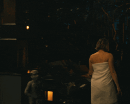 Woman in White Towel Walking Deck at Night