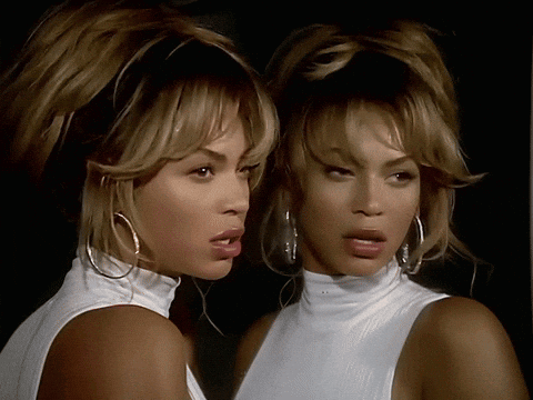 Woman in White Turtleneck Looking in Mirror