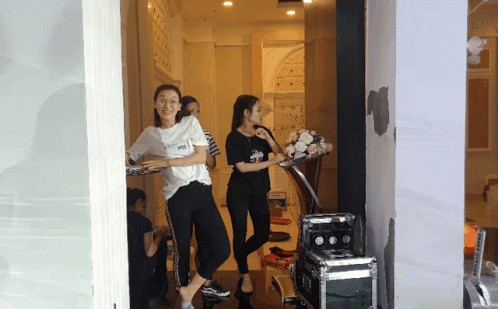 Woman in White Vans Shirt Standing in Doorway