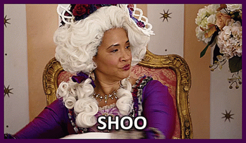 Woman in White Wig Saying Shoo