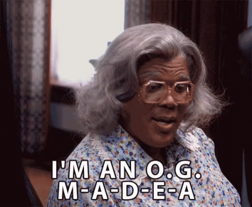 Woman In Wig And Glasses Saying I'm An O.G. M-A-D-E-A GIF