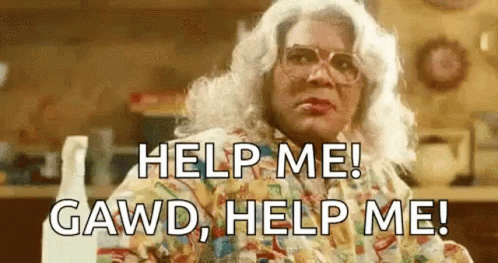 Woman In Wig And Glasses Sitting In Kitchen GIF