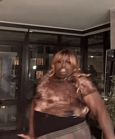 Woman in Wig Dancing With Hands in Air