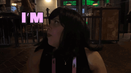Woman in Wig Says Overstimulated in Pink Letters