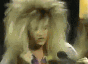 Woman in Wig Talking Into Microphone