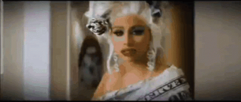 Woman in Wig With Dollar Bill Around Shoulder