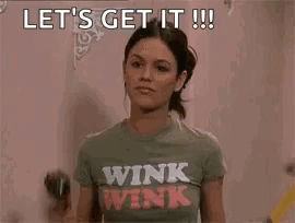 Woman in Winking Shirt Holding Drill and Hammer