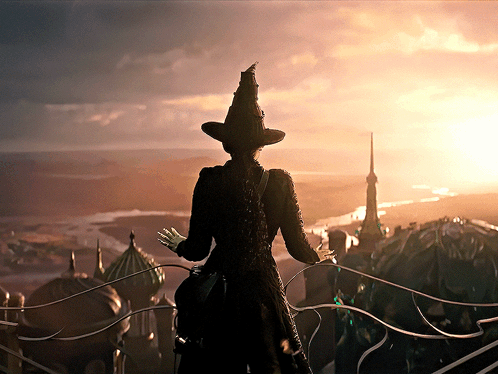Woman in Witch Hat on Balcony Overlooking City