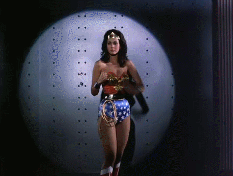 Woman In Wonder Woman Costume In Front Of Spotlight GIF