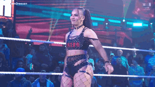 Woman in Wrestling Ring Before Crowd