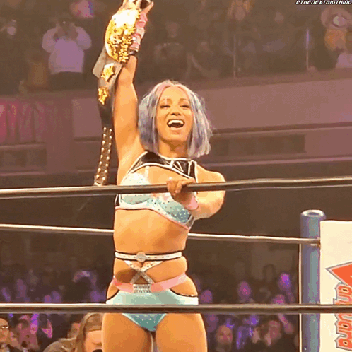Woman in Wrestling Ring Holding Championship Belt