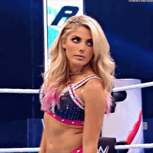 Woman in Wrestling Ring Holding Next Sign