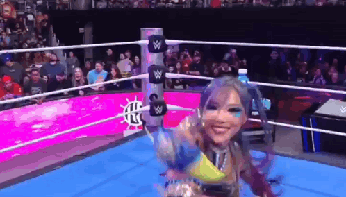 Woman In Wrestling Ring Holding Water Bottle GIF