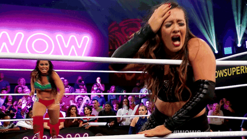 Woman In Wrestling Ring With Neon Sign Saying Now GIF