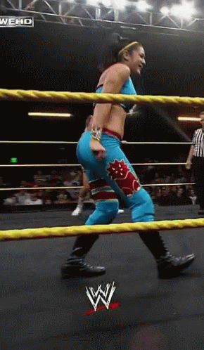 Woman in Wrestling Ring With WWE Logo