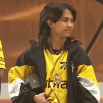 Woman In Yellow And Black Jacket Holding Medal GIF
