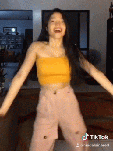Woman in Yellow Crop Top and Pink Pants Dancing