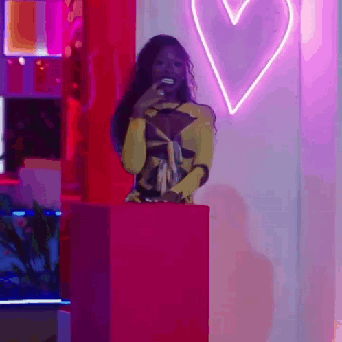 Woman in Yellow Dress and Pink Box With Heart