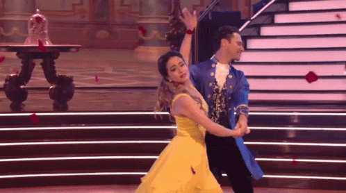 Woman in Yellow Dress Dancing With Man