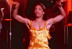 Woman in Yellow Dress Flexing Muscles