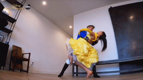 Woman In Yellow Dress Lifted By Man In Blue Costume Disney Dancing GIF