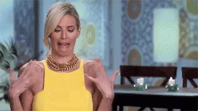 Woman in Yellow Dress Making Funny Face Holding Arms Out