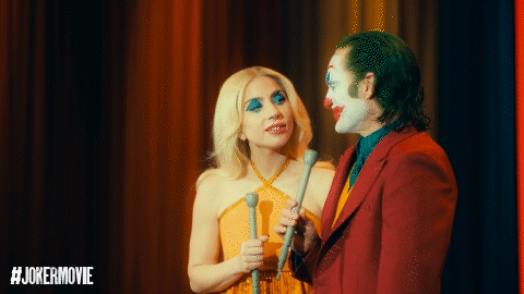 Woman in Yellow Dress Next to Man in Joker Costume