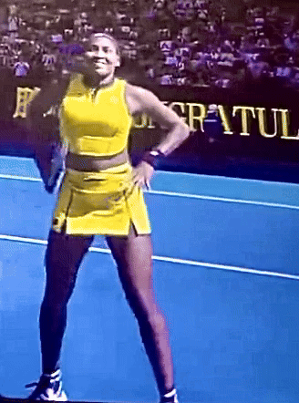 Woman in Yellow Dress on Blue Tennis Court