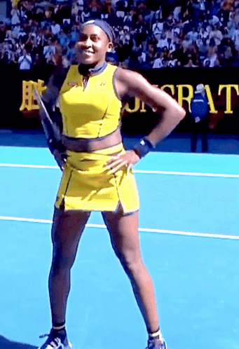 Woman in Yellow Dress on Tennis Court With Sr-At Sign