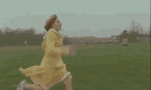 Woman In Yellow Dress Running In Field GIF
