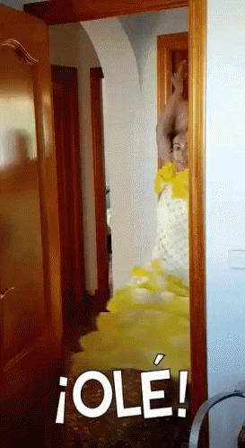 Woman in Yellow Dress Standing in Doorway