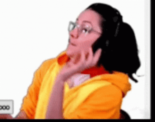 Woman In Yellow Hoodie Talking On Phone GIF