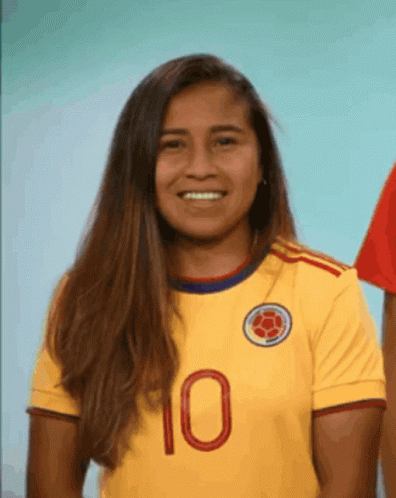 Woman In Yellow Jersey Number 10 Smiles GIF