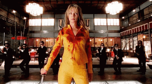 Woman In Yellow Outfit Holding Sword GIF