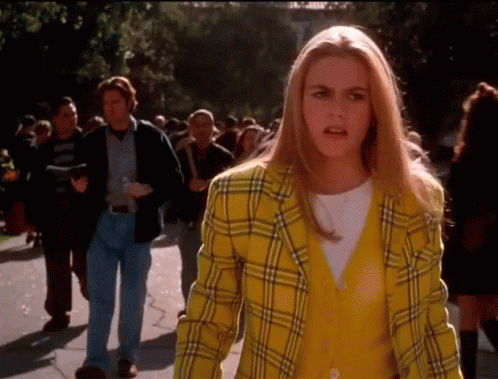 Woman in Yellow Plaid Jacket Talking to Crowd