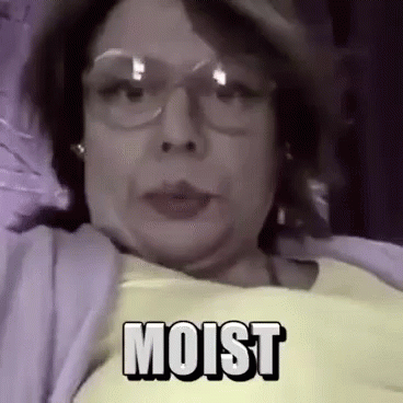 Woman In Yellow Shirt And Glasses Lying In Bed Moist GIF