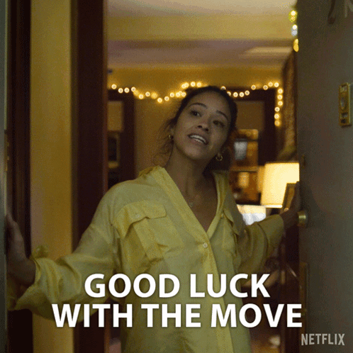 Woman In Yellow Shirt In Front Of Good Luck With The Move Door GIF