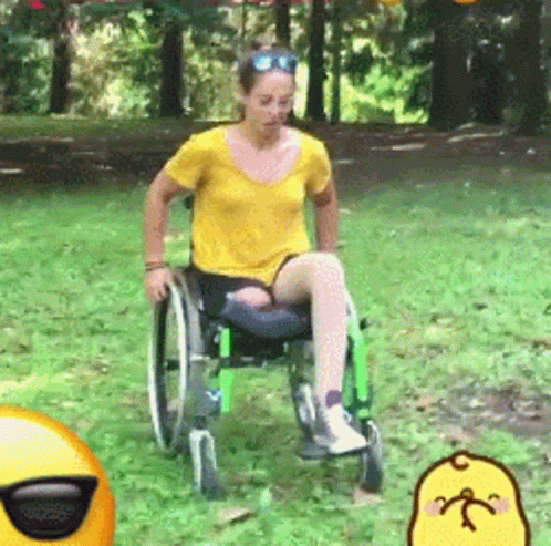 Woman in Yellow Shirt in Wheelchair in Park