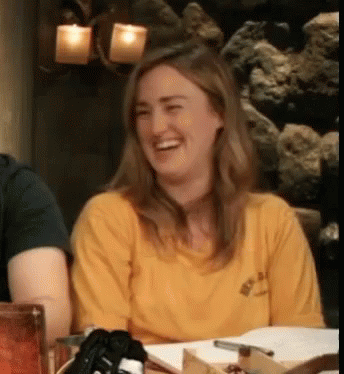 Woman In Yellow Shirt Laughing At Table With Others GIF