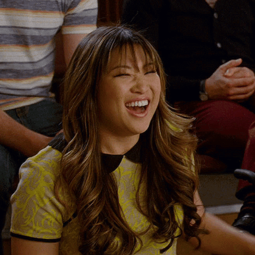 Woman in Yellow Shirt Laughing in Crowd