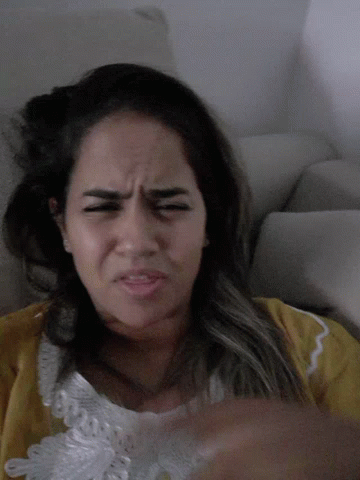 Woman In Yellow Shirt Making Funny Face GIF