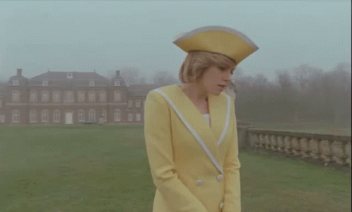 Woman In Yellow Suit And Hat GIF