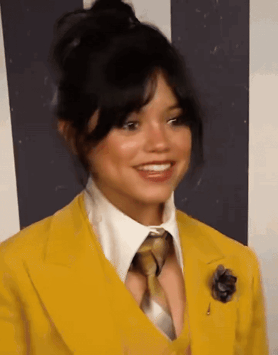 Woman In Yellow Suit And Tie Smiling GIF