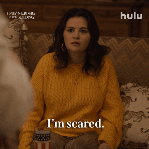 Woman in Yellow Sweater Sitting on Couch