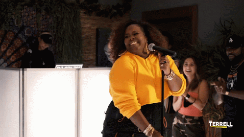 Woman In Yellow Sweatshirt Singing GIF