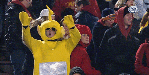 Woman in Yellow Teletubbies Costume in Crowd Watching Fox Sports Game