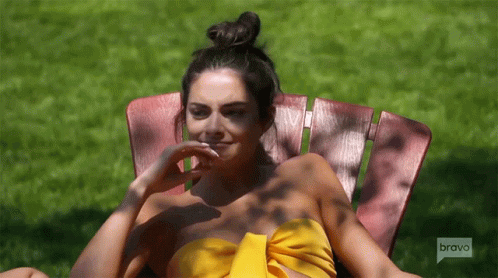 Woman in Yellow Top Sitting in Chair Saying Bravo