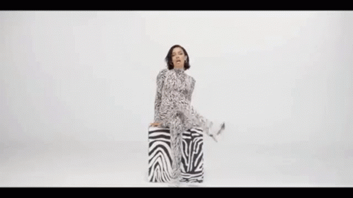 Woman in Zebra Print Jumpsuit Sitting