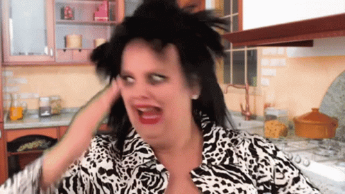 Woman In Zebra Print Making Funny Face In Kitchen GIF
